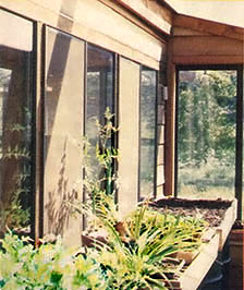 A winter vegetable garden resides atop five 55-gallon water-filled heat storage drums inside the greenhouse.